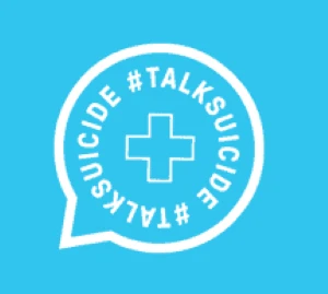 blue background with a white speech bubble, with a hollow cross in the middle and the words TALK SUICIDE around the edge