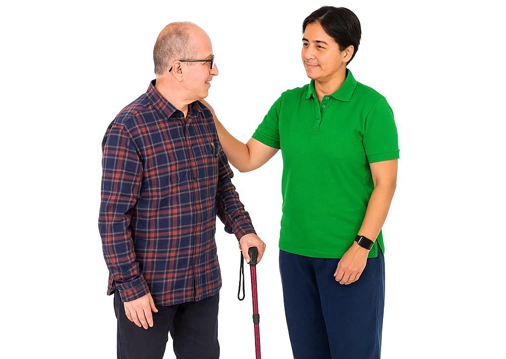 an older person with a learning disability is supported by a care worker