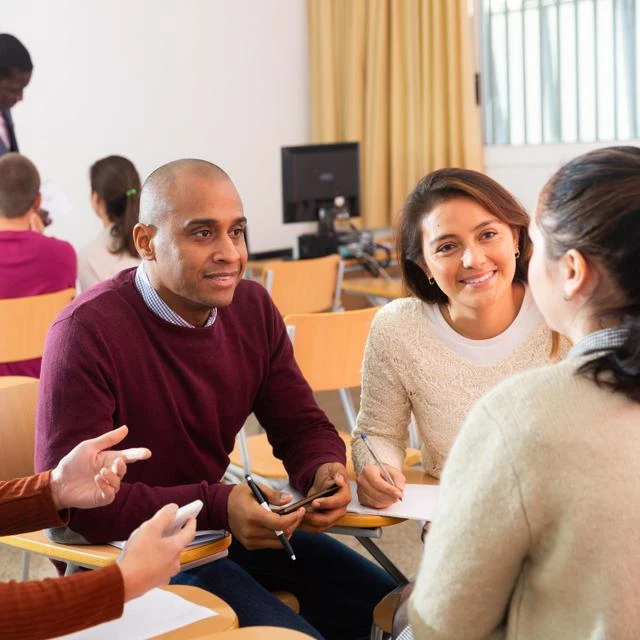 adult learners having a conversation in a classroom