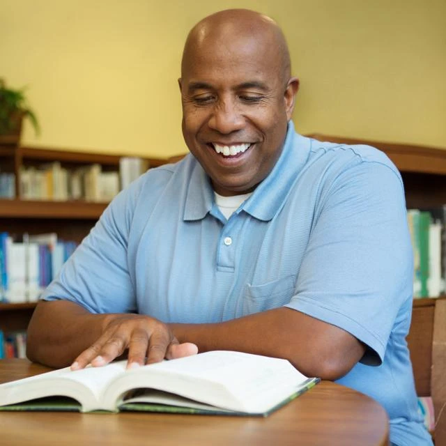 Male learner studying in library