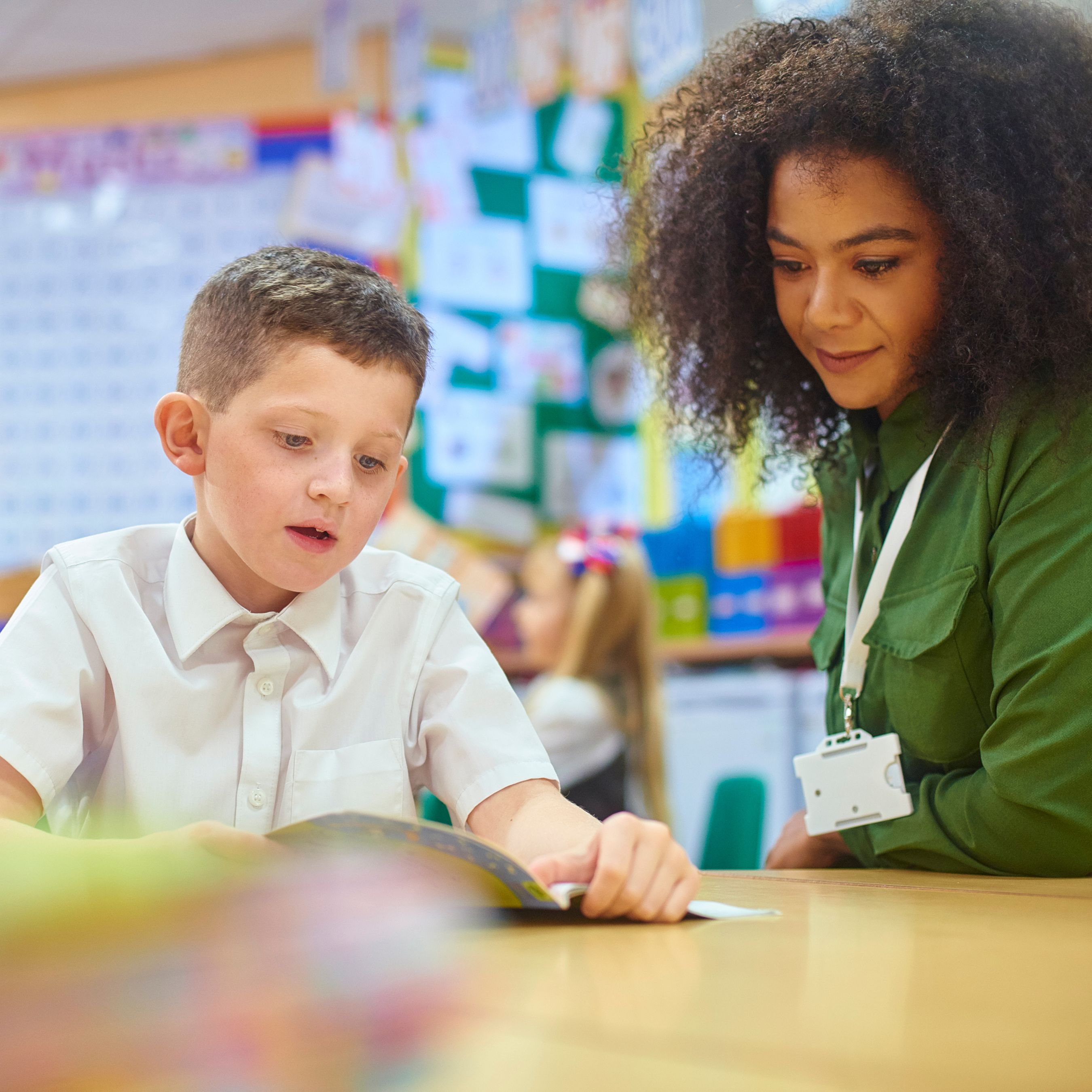 pupil and school staff in classroom