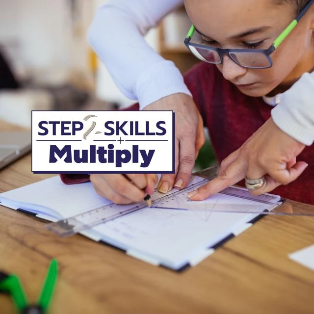 An image of a child using maths instruments and a notebook, being supported by an adult