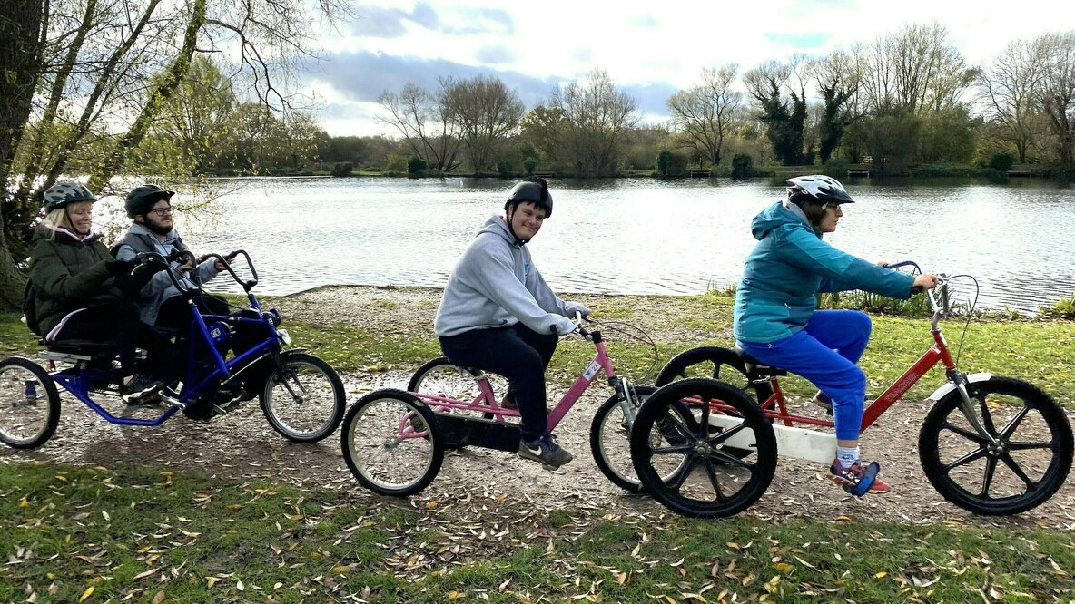 People riding bikes near a lake