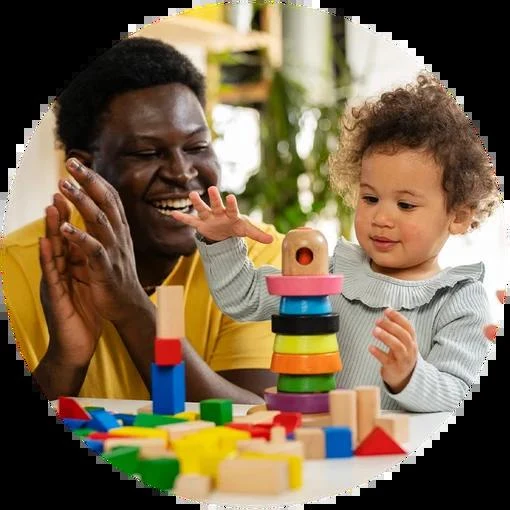 Adult and young child playing with building blocks