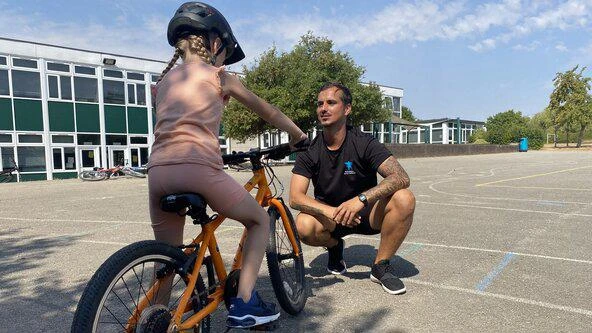 child on bike with instructor