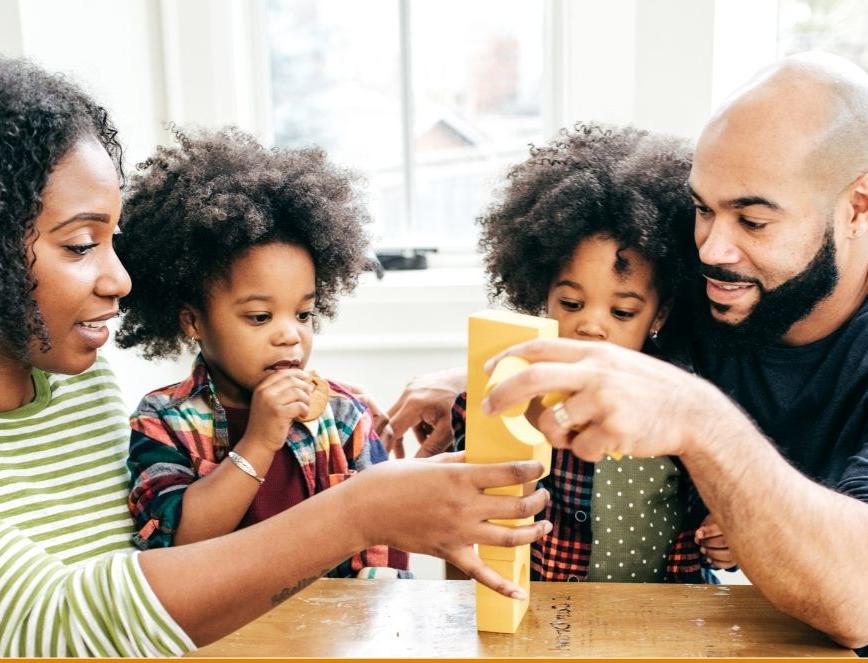 A family play a game together at a table