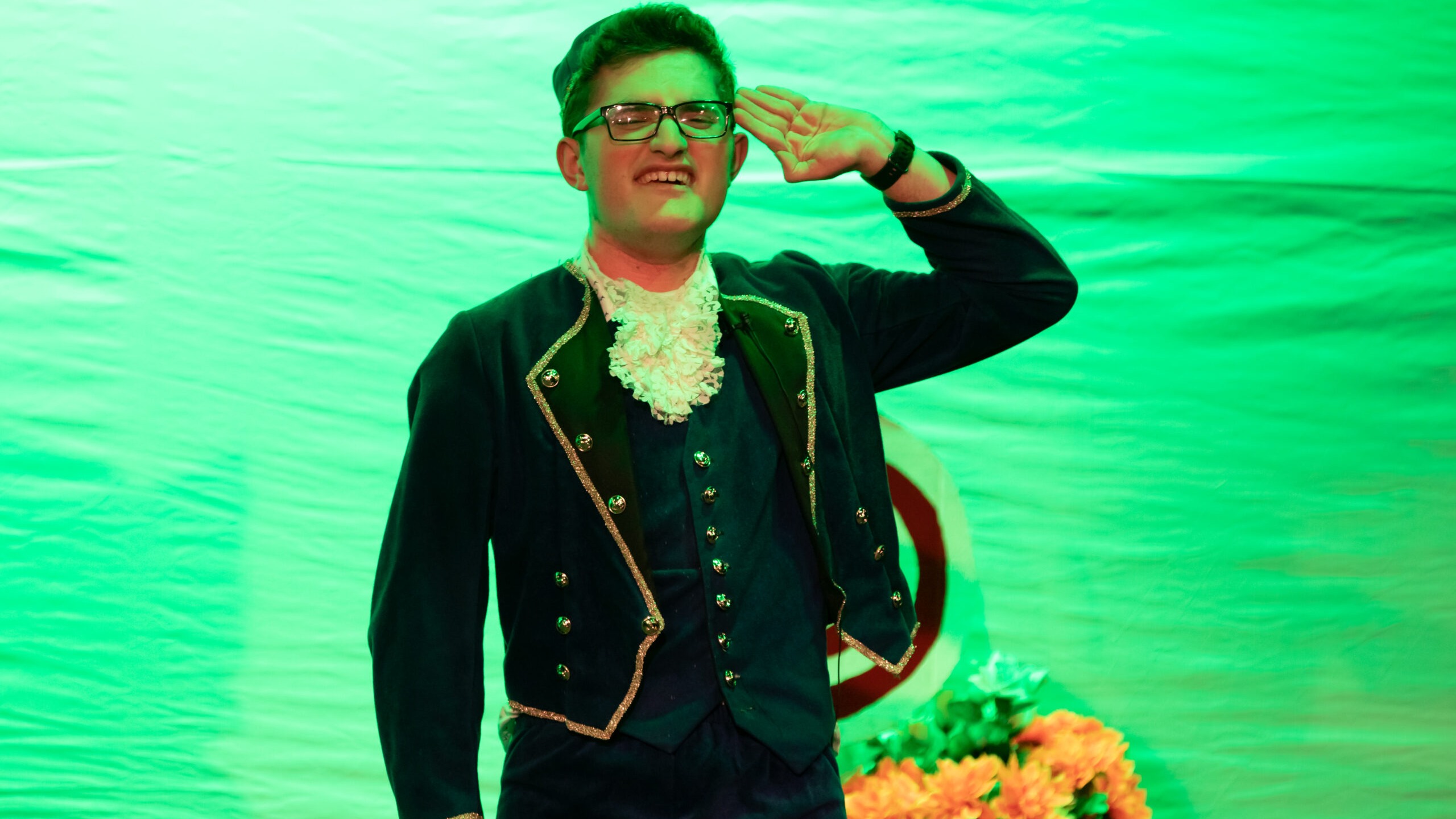 Photo of young man dressed up on stage