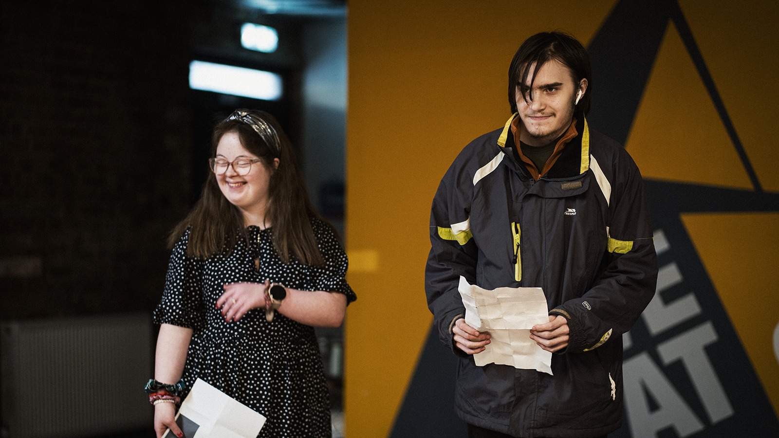 photo of 2 young adults on stage