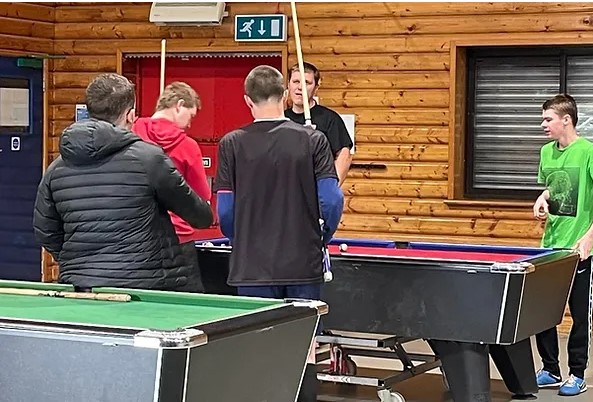 Image of young people playing pool
